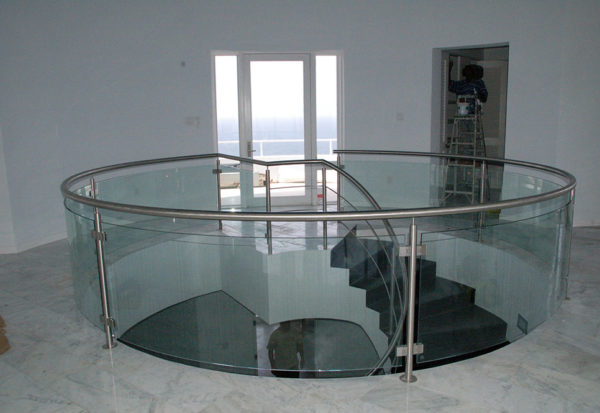 Custom curved glass railing with stainless steel posts