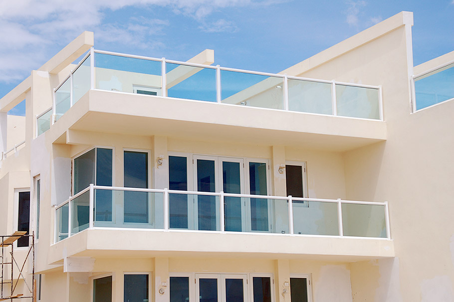 White home with glass balcony railings