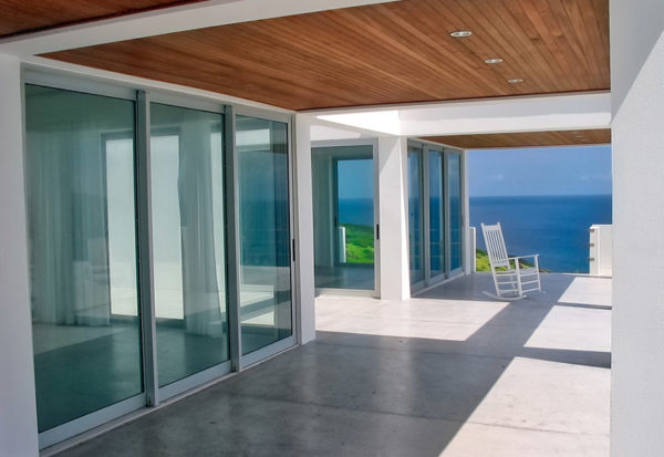 Glass walls with a patio and sea view