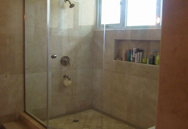 Glass enclosure for shower with a step