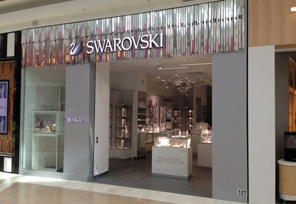 A store front of a jewelry shop with a large window.